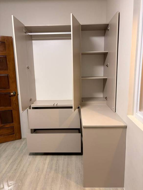 Taupe wardrobe run with a drawer bank and desk return