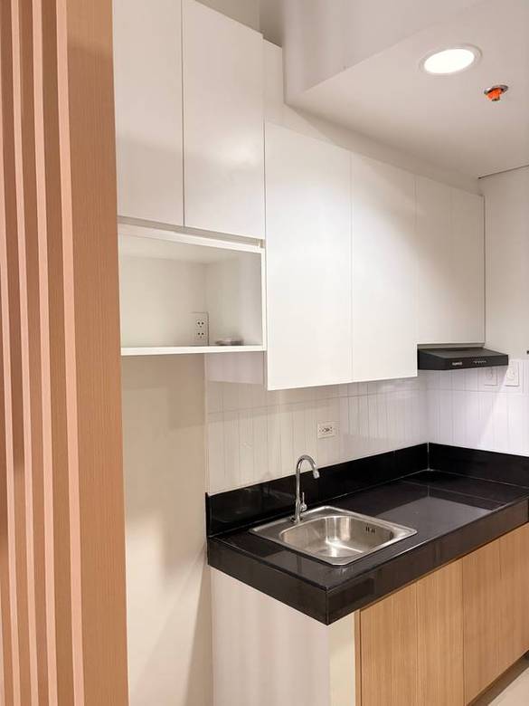 White uppers over oak base cabinets with a black granite counter