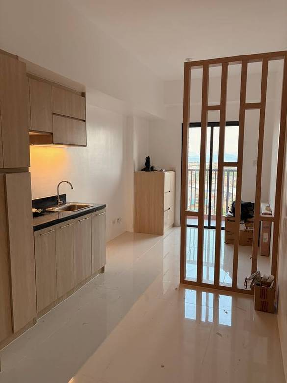 Oak laminate kitchen behind a timber-fin room divider
