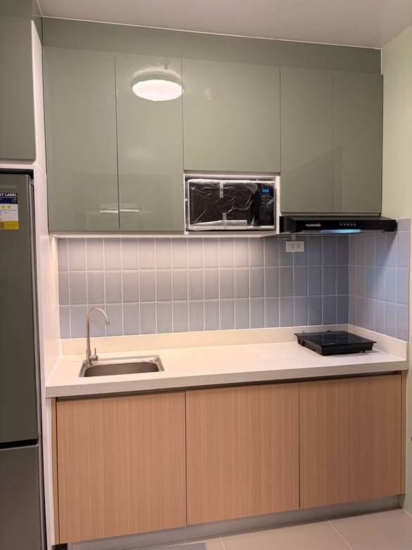 Kitchen, TV console, mirror partition and closet in a renovated condo unit