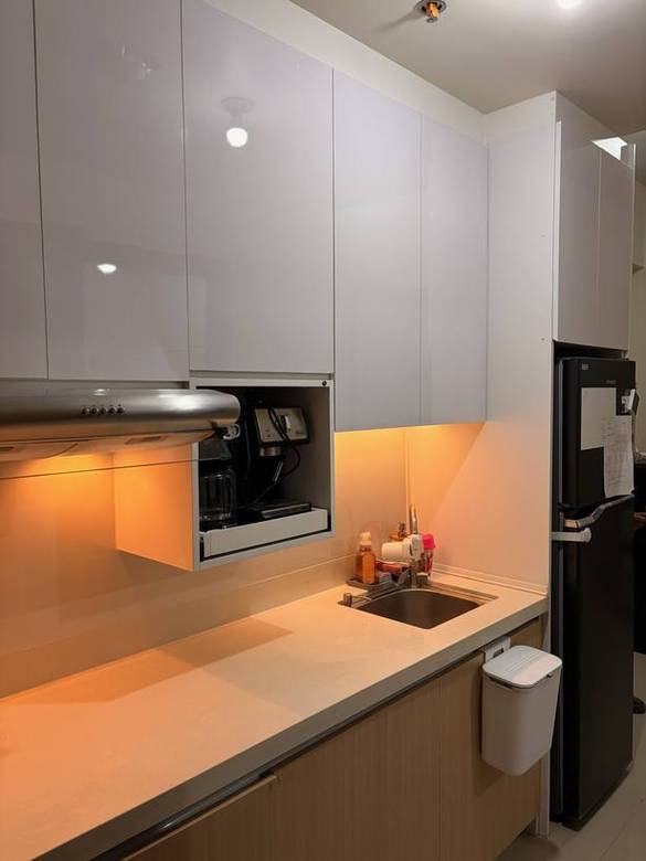 Handleless white gloss kitchen with a built-in coffee station