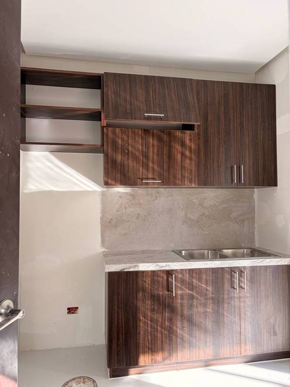 Dark walnut overheads and base cabinets over a stone counter