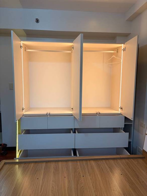Full-height wardrobe with an LED-lit interior and arch return