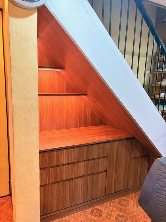 Walnut drawers and lit open shelving under the stair