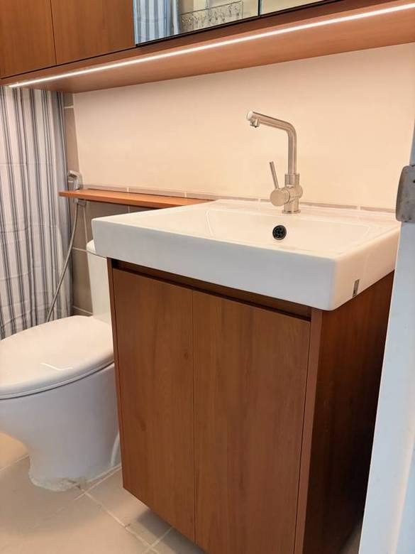 Floating timber vanity with a vessel basin and mirror cabinet
