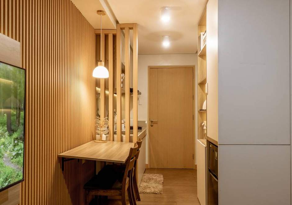 Timber slat divider, fold-out dining counter and kitchen in a renovated condo unit